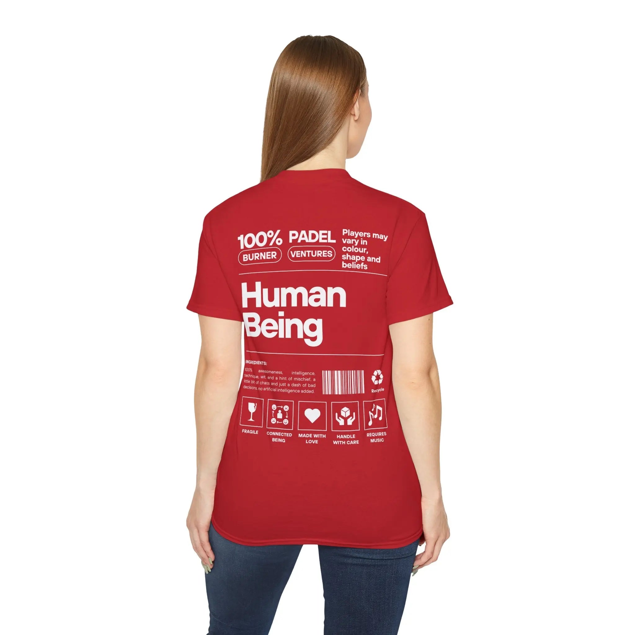 PSF Collective A woman with straight brown hair wears the Limited Edition "Human Being" Tee by Printify, featuring bold white text and icons like "100% Human Being" on the back. She faces away from the camera in her red t-shirt. Designed for the Unwind