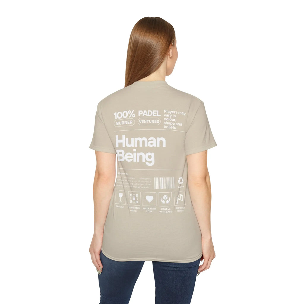 PSF Collective Seen from behind, a person with long, straight hair wears the Printify Limited Edition "Human Being" Tee in beige, featuring white text and graphics like “100% PADEL VENTURE,” “Human Being,” and Padel in the Dust icons. Designed for the Unwind