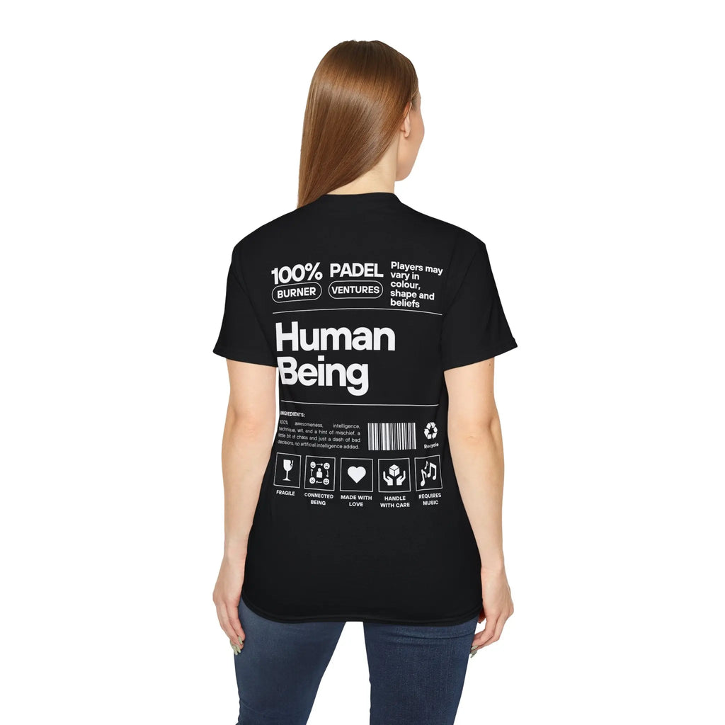 PSF Collective A woman with straight brown hair, seen from behind, wears the Printify Limited Edition "Human Being" Tee in black, featuring bold white "100% Human Being" text along with symbols and care instructions. Designed for the Unwind
