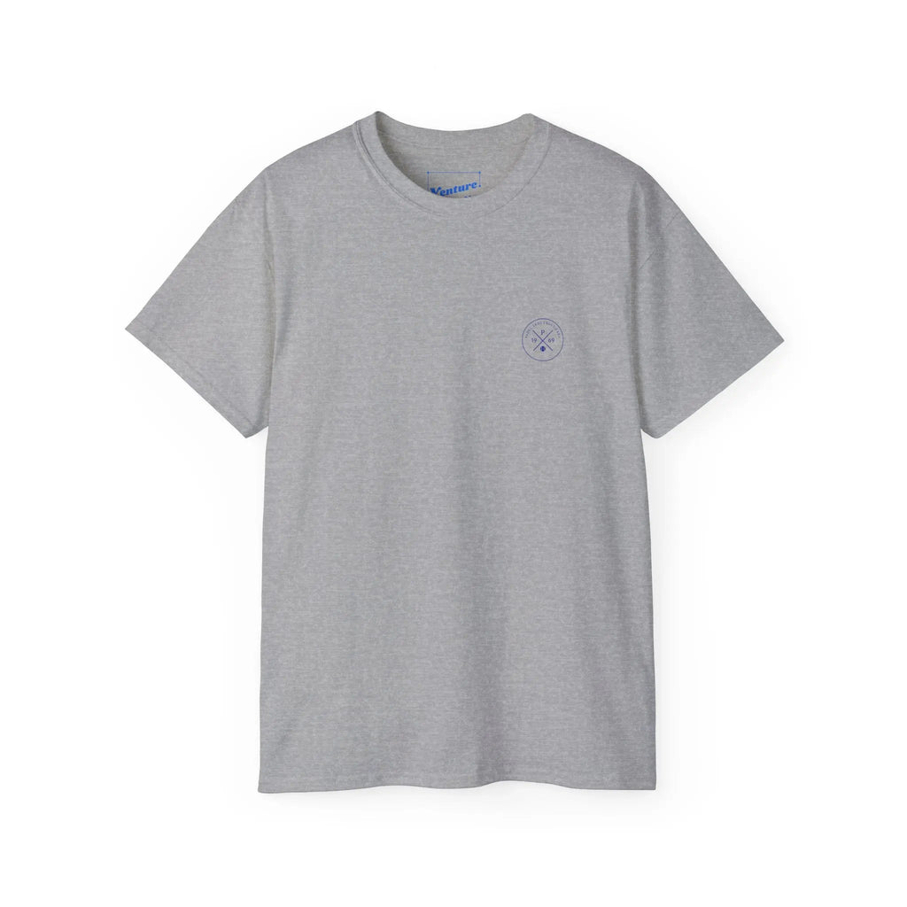 PSF Collective The Printify Limited Edition - Padel in the Dust Tee is a light gray short-sleeve shirt featuring a small circular blue logo on the left chest, shown on a white background. Designed for the Unwind