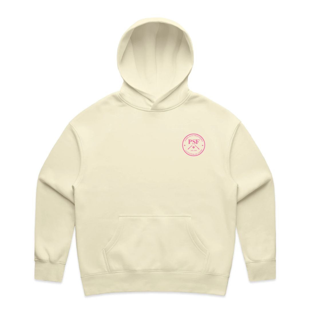 PSF Collective The Summer Arch in Pink Ladies Hoodie is cream-colored with a front pocket and hood. A small, round pink “PSF” logo with crossed oars appears on the left chest. The cozy hoodie is shown against a plain white background. Designed for the Unwind