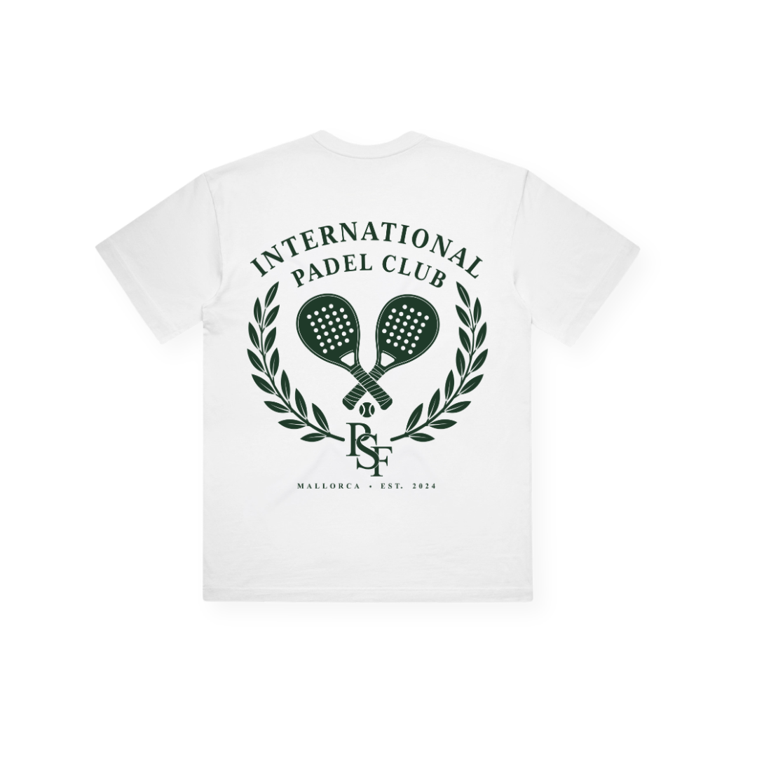 PSF Collective Introducing the International Crest Box Tee: a white T-shirt featuring "INTERNATIONAL PADEL CLUB" in green, positioned above two crossed padel rackets inside a laurel wreath. Beneath the design are the initials "ISF" and the text "MALLORCA • EST. 2024," all in green. This heritage tee showcases the signature crest on the back, offering post-match style that's perfect for padel enthusiasts. Designed for the Unwind