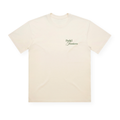 PSF Collective The Palma Box Tee is a plain cream-colored box-fit t-shirt shown laid flat. On the left chest, it features small black script reading “Padel Jinetairos,” a subtle nod to Palma de Mallorca style. Designed with a classic crew neck and short sleeves, the tee is free of any additional graphics or details. Designed for the Unwind
