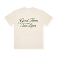 PSF Collective The Good Times and Tan Lines in Green Box Tee is a cream-colored summer t-shirt shown laid flat from the back. “Good Times and Tan Lines” is printed in bold, elegant green script across the back. This beach shirt features short sleeves and a lightweight feel with no additional visible designs or logos. Designed for the Unwind