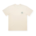 PSF Collective A premium cotton Green Ink Box tee is displayed flat on a white background. The off-white t-shirt features a minimal, clean design with a small circular logo reading PSF, bordered on the left chest—ideal for fans of the International Padel Club. Designed for the Unwind