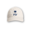 PSF Collective The Palm Cap showcases a beige design with a blue embroidered palm tree above striking “PSF” lettering, inspired by Mediterranean style and centered on the front. The cap is displayed against a white background with a subtle shadow beneath it. Designed for the Unwind