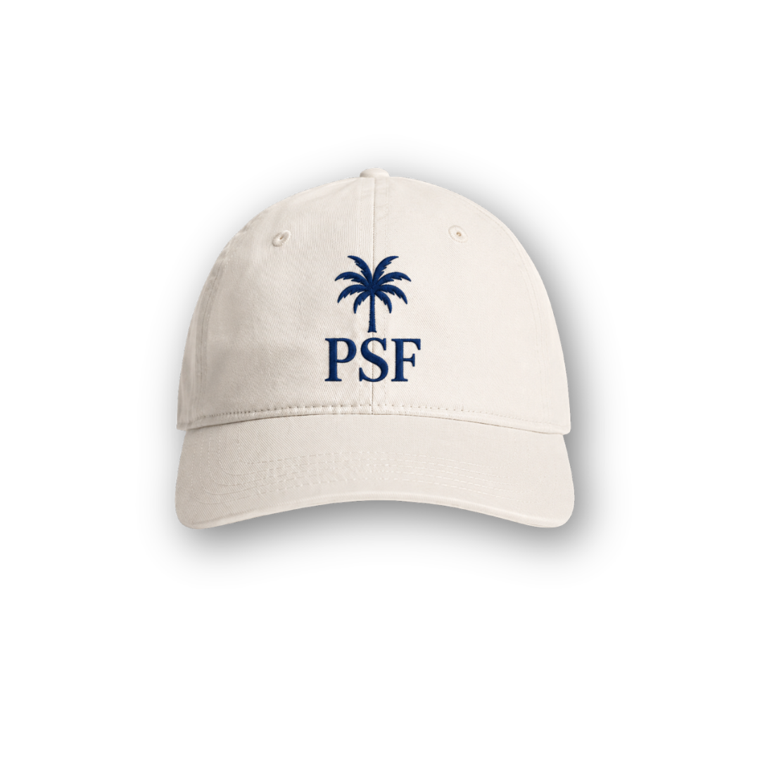 PSF Collective The Palm Cap showcases a beige design with a blue embroidered palm tree above striking “PSF” lettering, inspired by Mediterranean style and centered on the front. The cap is displayed against a white background with a subtle shadow beneath it. Designed for the Unwind