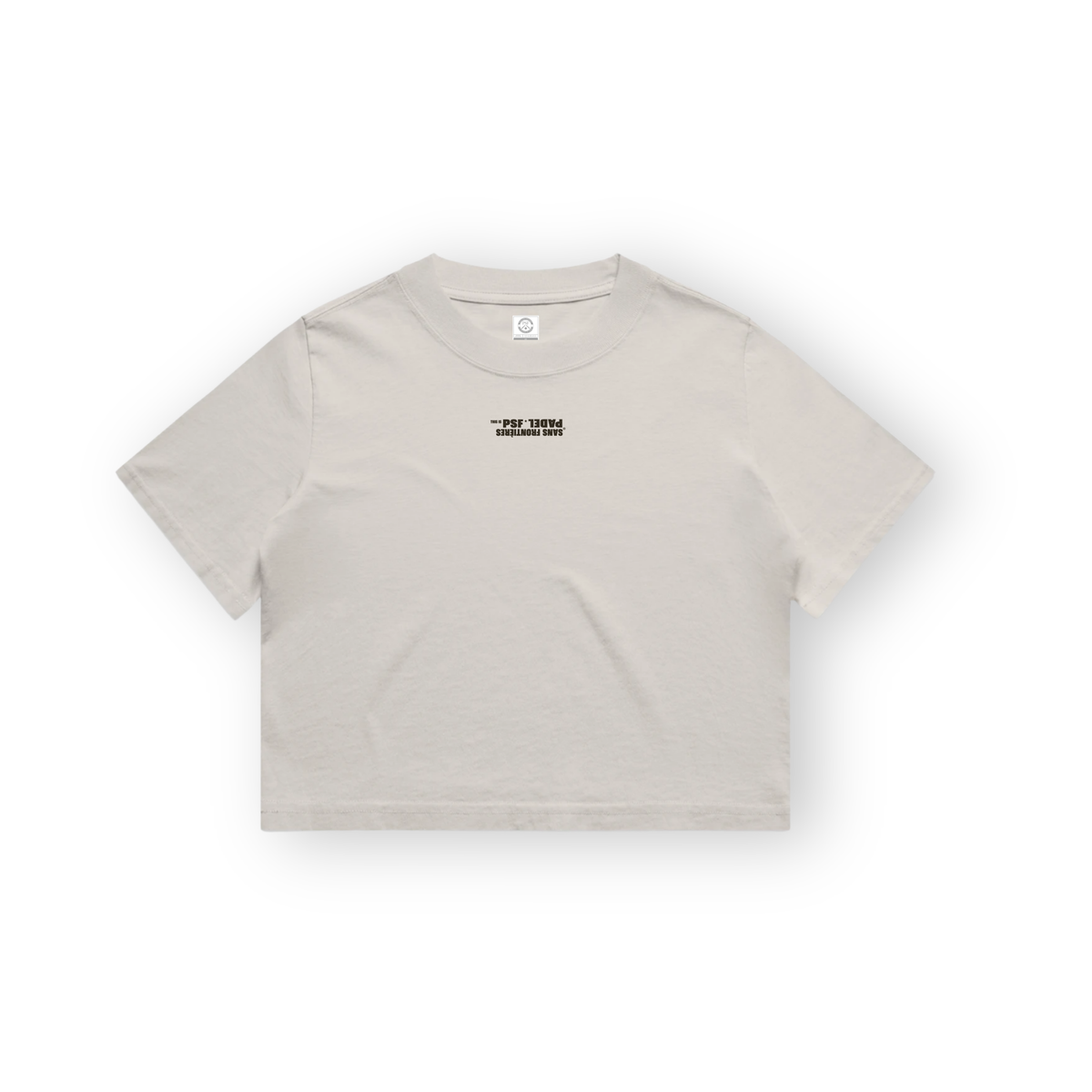 PSF Collective A light beige cropped PSF-129 Padel t-shirt with short sleeves is centered against a white background, featuring upside-down black text on the chest that reads SANS FRONTIÈRES PADEL. Designed for the Unwind