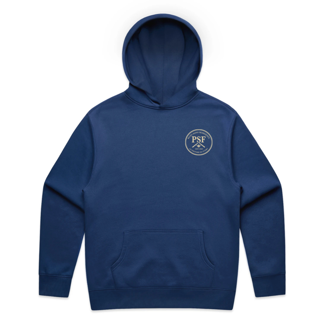 PSF Collective The Hazy Jane Hoodie is a sustainable navy blue hoodie featuring a front pocket, drawstring hood, and a round light emblem on the left chest with “PSF,” mountains, and waves for a retro sunset vibe. Photographed on a plain white background. Designed for the Unwind